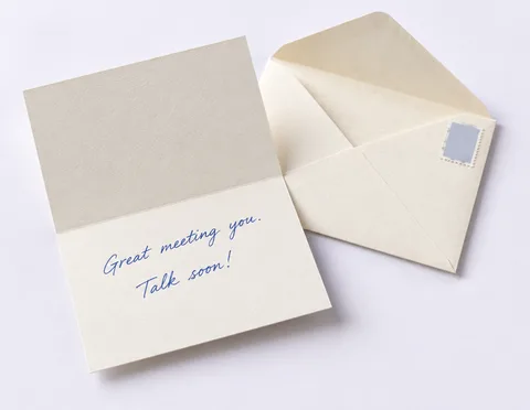 A handwritten note card reading “Great meeting you. Talk soon!” beside its envelope